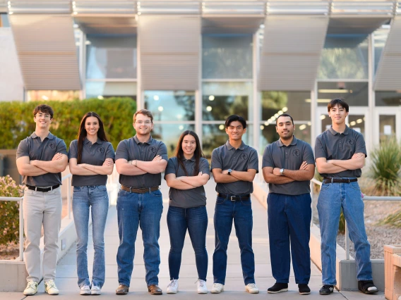 Students pose outdoors on the University of Arizona campus